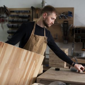 man-working-wood-engraving-workshop